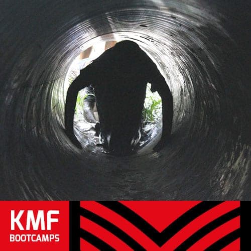 A child crawling through a tunnel at a KMF bootcamp
